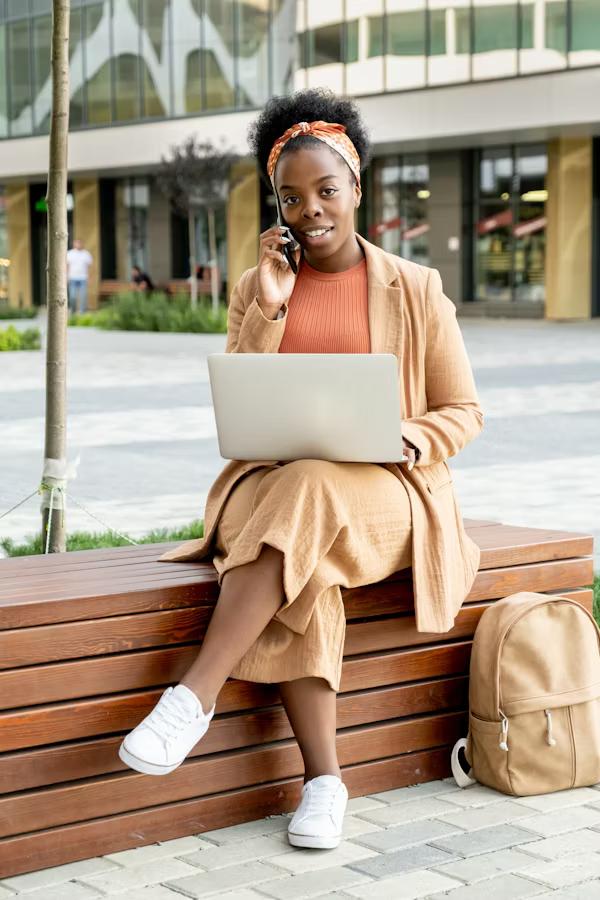 Person with laptop on a bench